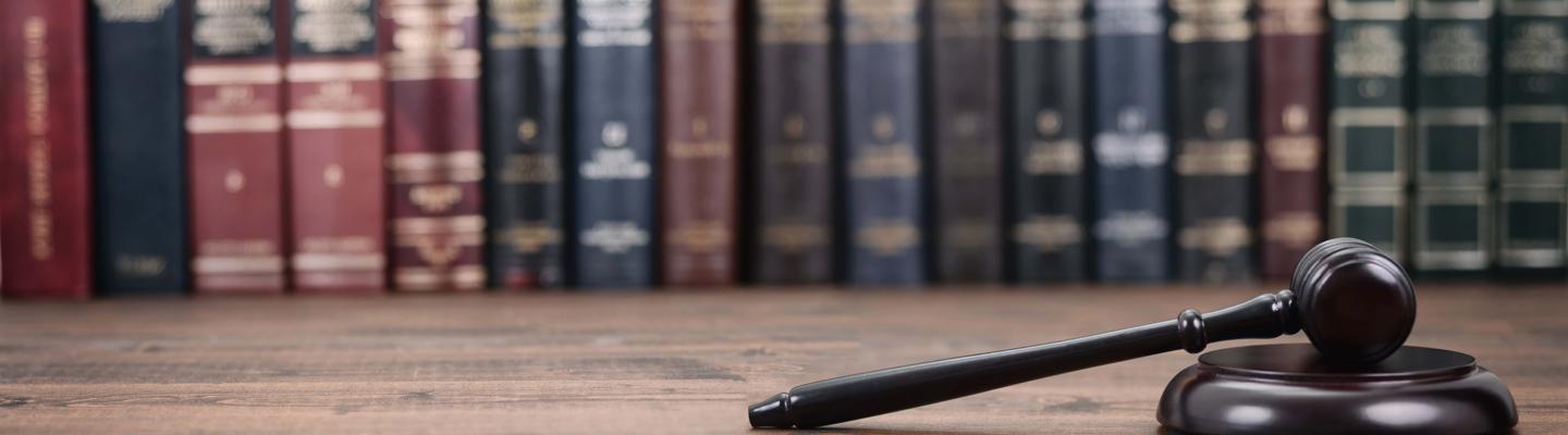 gavel on table with books in the background